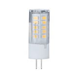 Small LED lamp with transparent plastic housing and two metal pins for energy-saving lighting