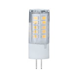 Small LED lamp with transparent plastic housing and two metal pins for energy-saving lighting