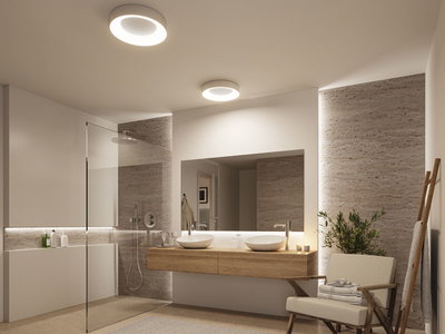 Modern bathroom with two white ceramic sinks on wooden vanity and round ceiling lights for ambient lighting.
