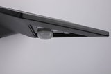 Black LED wall light with integrated motion sensor made of plastic for indoor use