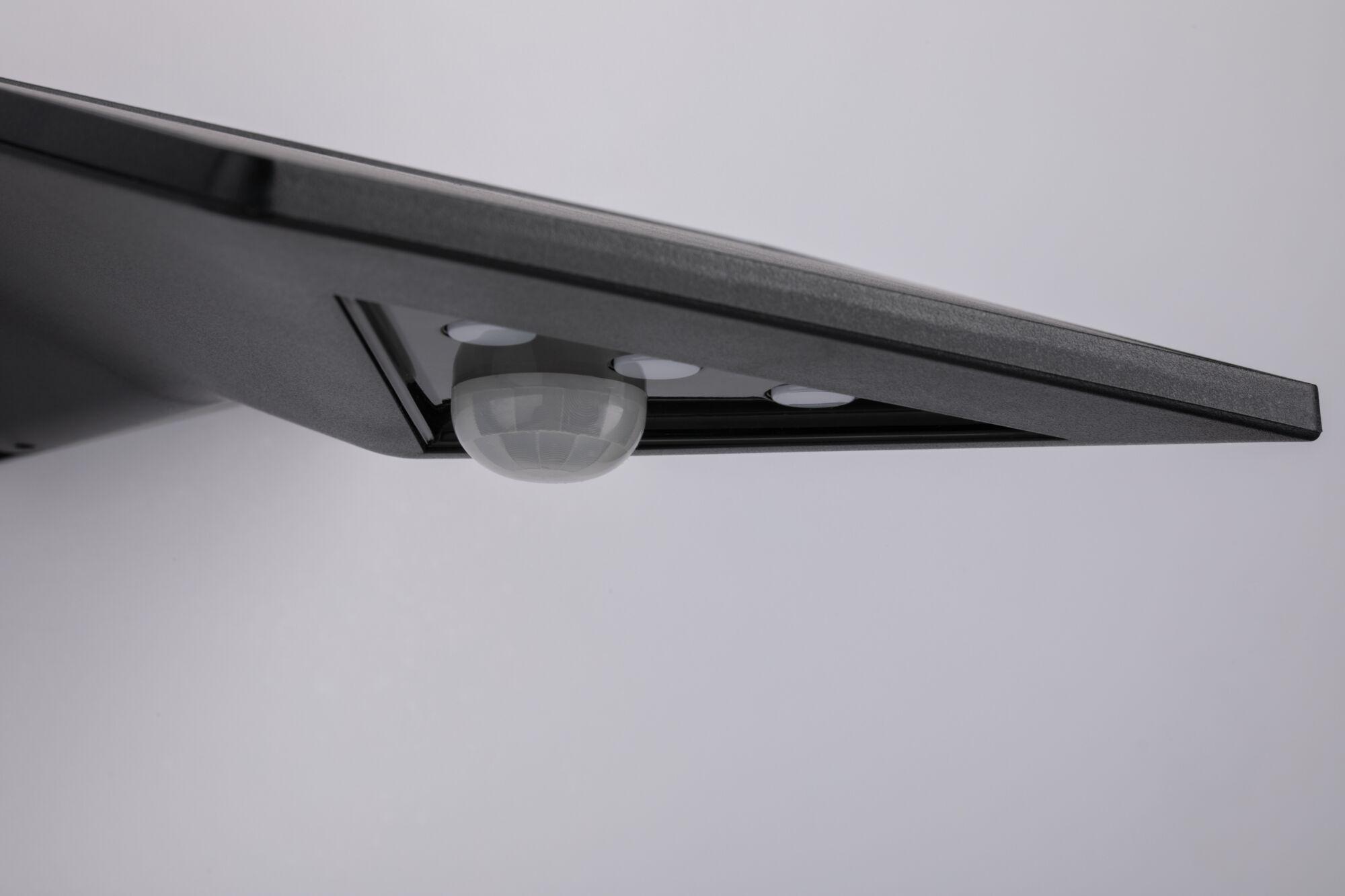 Black outdoor LED solar light with motion sensor and weatherproof housing for garden lighting