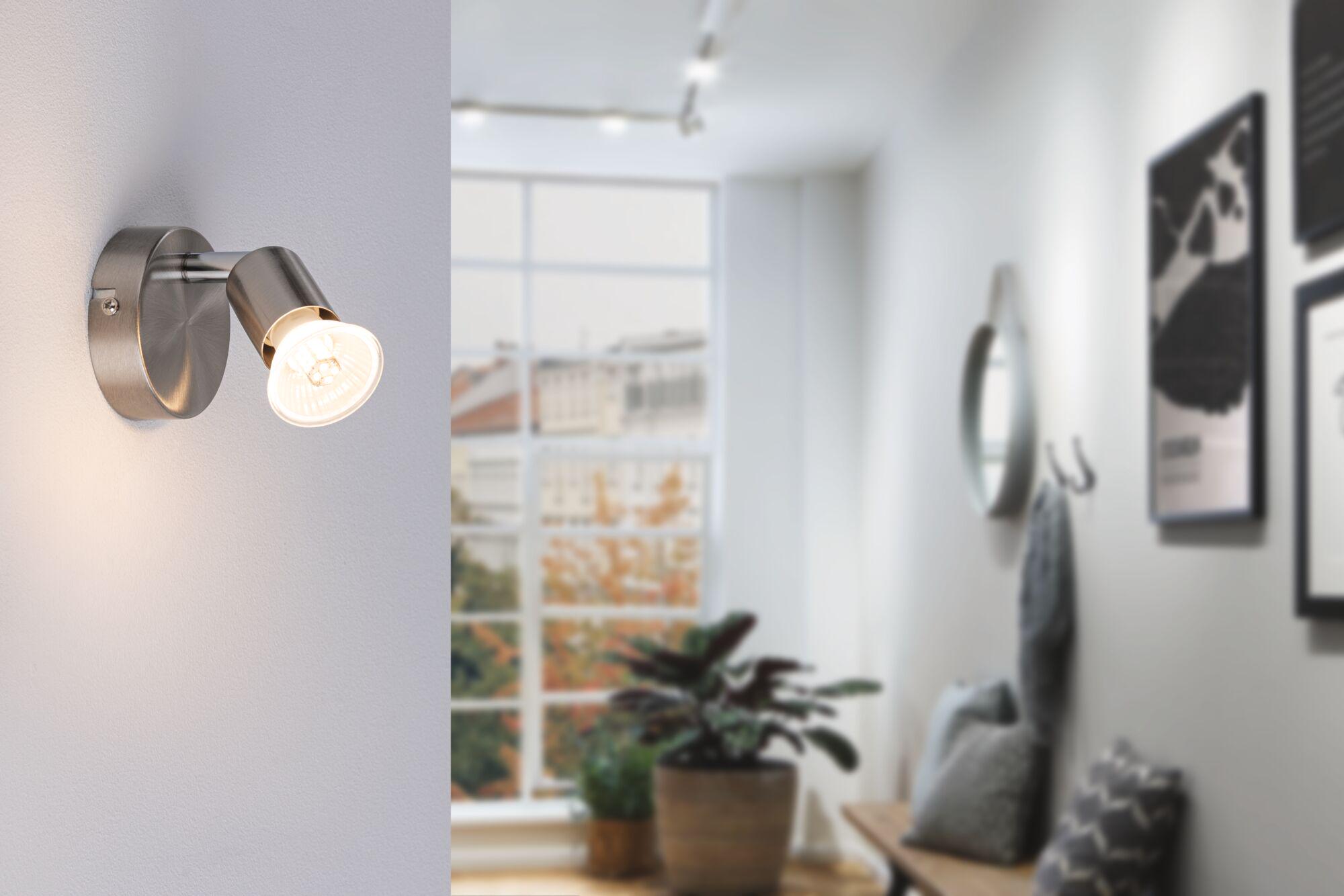 Modern LED wall spotlight in brushed silver metal for focused indoor lighting.