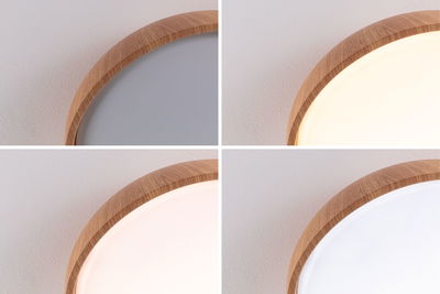 Vier close-ups van een ronde plafondlamp met houten frame en instelbare lichtkleur.