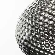 Close-up of shiny silver metal surface with wavy textured pattern for decorative lighting