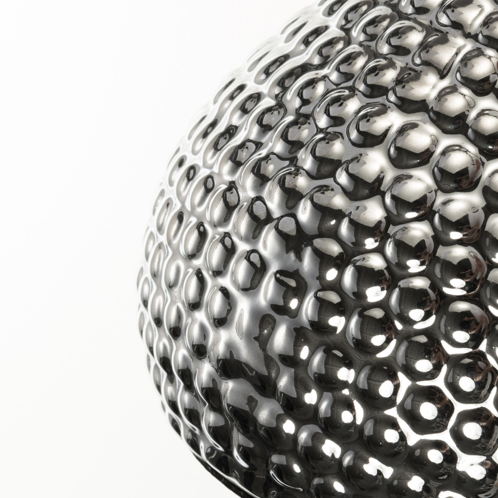 Close-up van glanzend zilverkleurig metalen oppervlak met golvend, gestructureerd patroon
