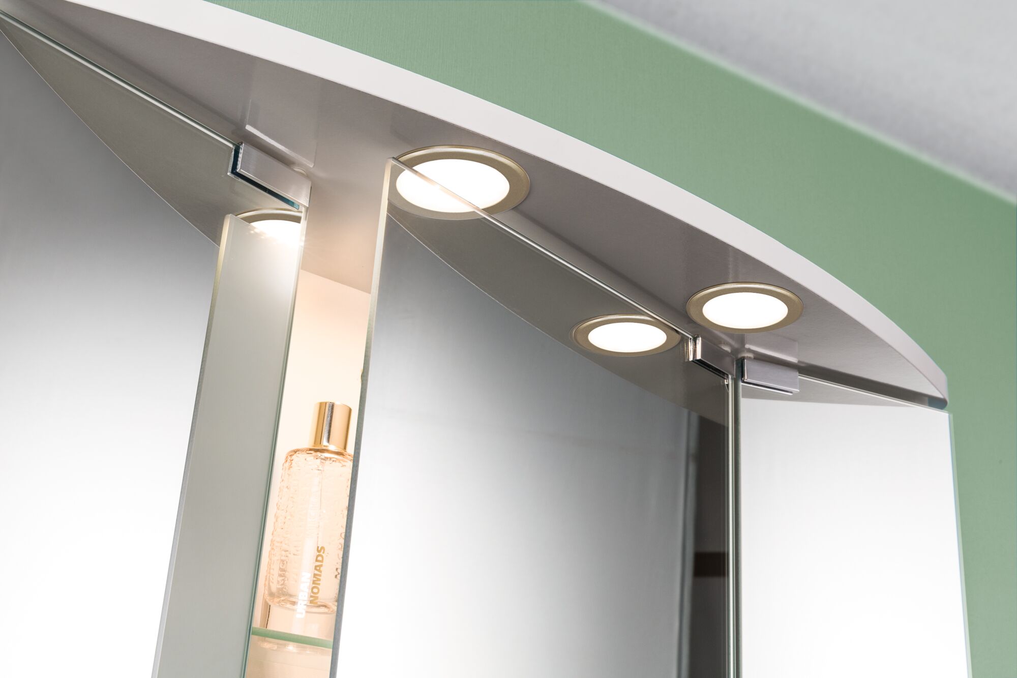 Round LED bathroom mirror light with warm white illumination and white frame for modern bathrooms.