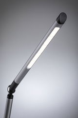 Modern silver aluminum LED desk lamp with warm white light for office and home use.