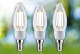 Three clear LED candle bulbs with E14 base emitting warm white light for energy-efficient lighting.