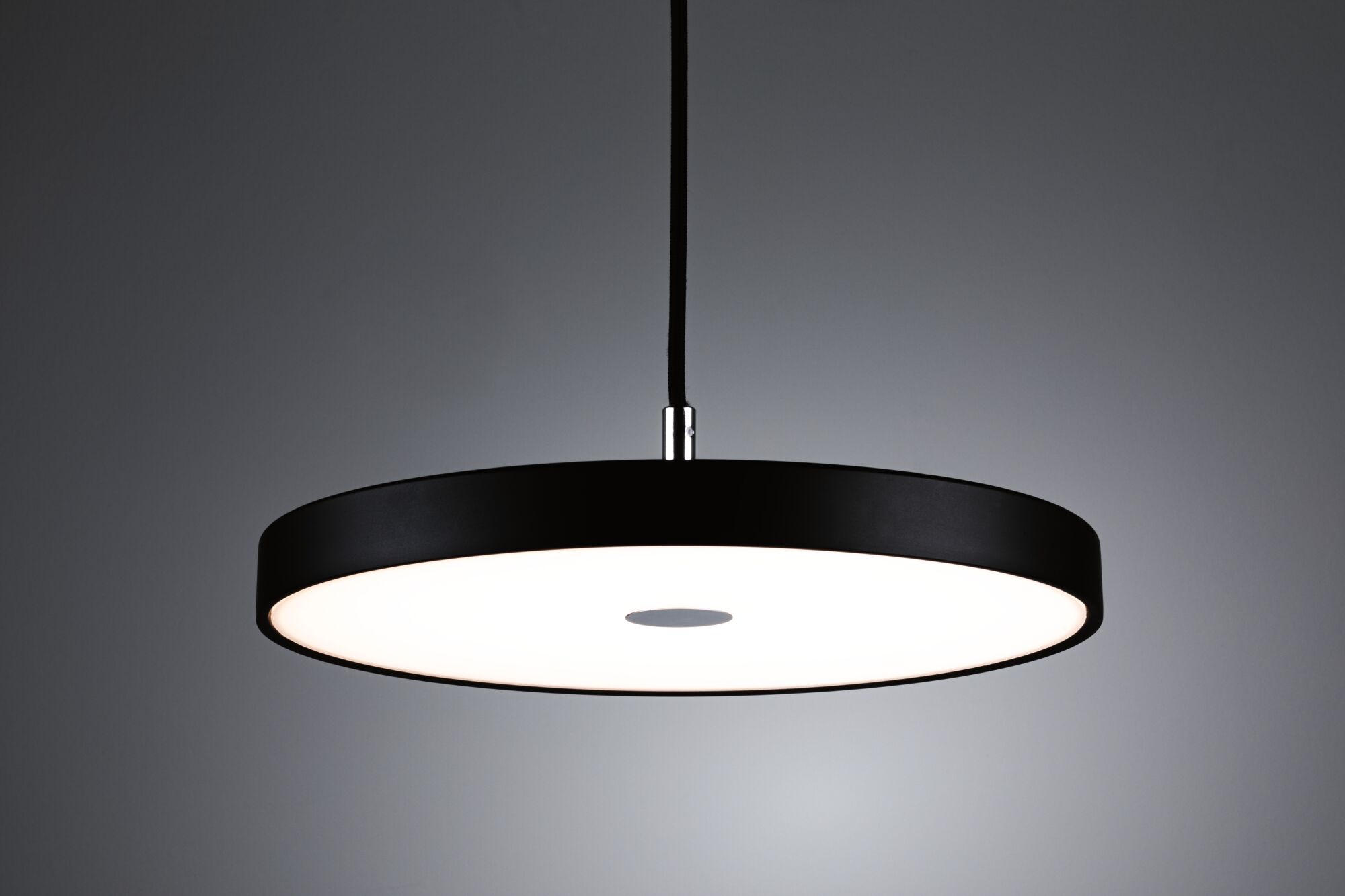 Modern round LED pendant light with black metal frame and white diffuser for living spaces.