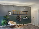 Modern hallway with grey and green wall, wooden ladder coat rack, and round rattan chair with cushion