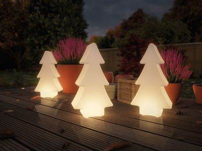 Three white LED decorative plastic trees lighting a terrace at dusk for garden lighting.