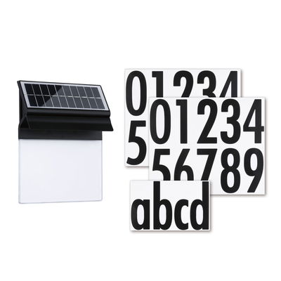 Black solar house number sign with white number and letter stickers for outdoor lighting.