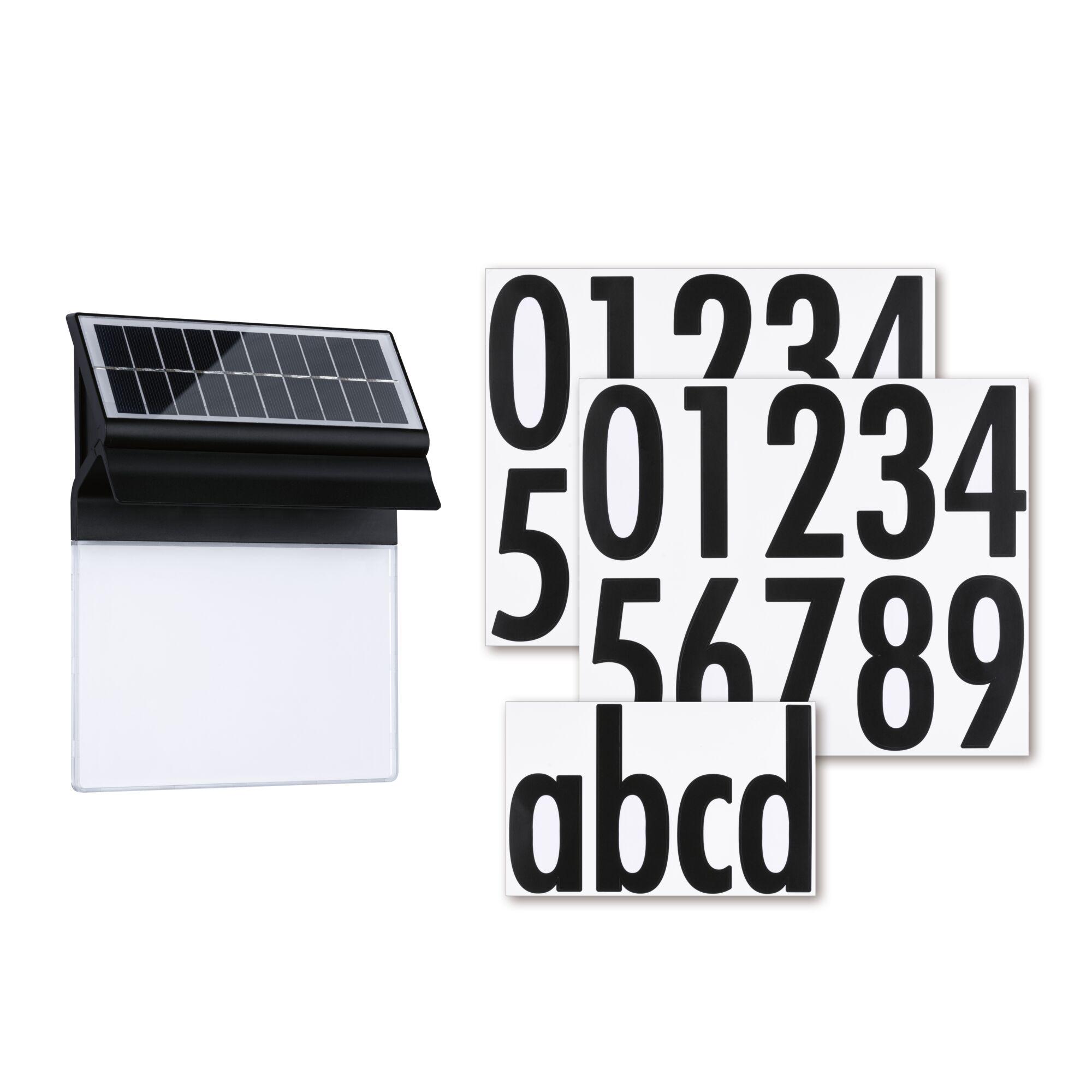 Black solar light with white panel and black number and letter stickers for house numbering.