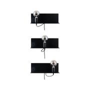 Three black metal wall lamps with exposed bulbs and cords for modern indoor lighting design