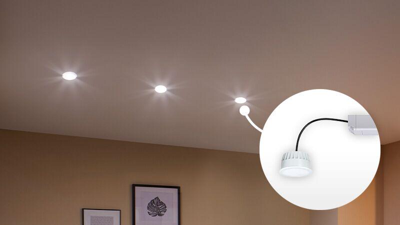 Three white LED recessed lights on ceiling with close-up of LED coin module for home lighting