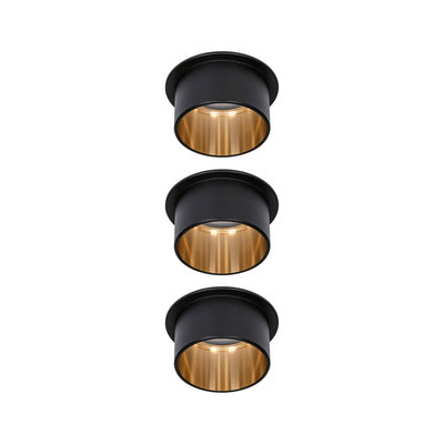 Three round black metal recessed lights with gold interior ring for modern LED lighting solutions