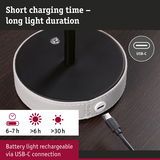 USB-C charging cable connected to round white leather base on dark wood, rechargeable battery light with long duration
