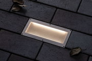 Rechthoekige inbouw LED-lamp van roestvrij staal met warm wit licht in donkere buitenbestrating
