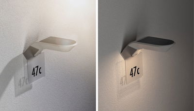 Modern white LED wall light with house number 47c, energy-saving outdoor lighting fixture