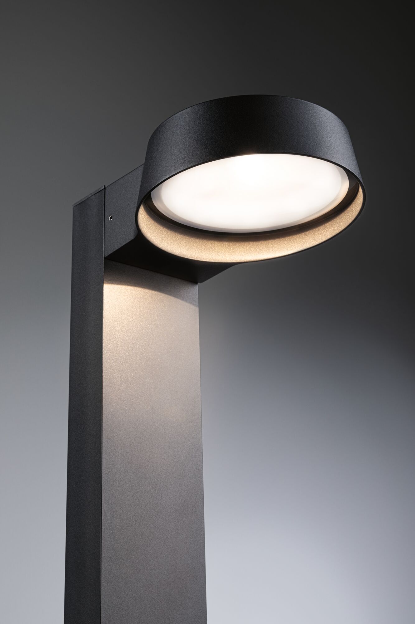Modern black aluminum outdoor wall light with round diffuser and warm white LED illumination