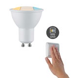 White GU10 LED bulb with color temperature switch and hand pressing white light switch for control