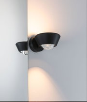 Black metal wall lamp with warm white light and modern design for stylish home lighting