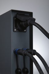Black metal housing with three connected black cables and blue connectors for lighting systems.