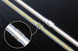 LED strip with transparent connector on black surface, flexible 24V lighting strip for interior use.