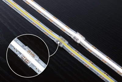 LED-strip med gennemsigtig forbindelse på sort overflade, fleksibel 24V belysningsstribe.
