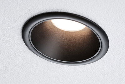 Black metal recessed spotlight with warm white LED light in white ceiling for living spaces