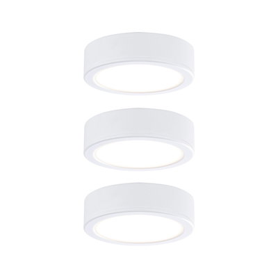 Three round white LED ceiling lights made of plastic with warm white light for modern interiors