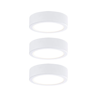 Three round white LED ceiling lights made of plastic with warm white light for modern interiors