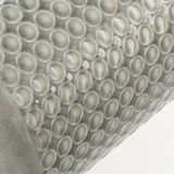 Close-up of grey ceramic surface with raised round patterns and glossy finish for home decor