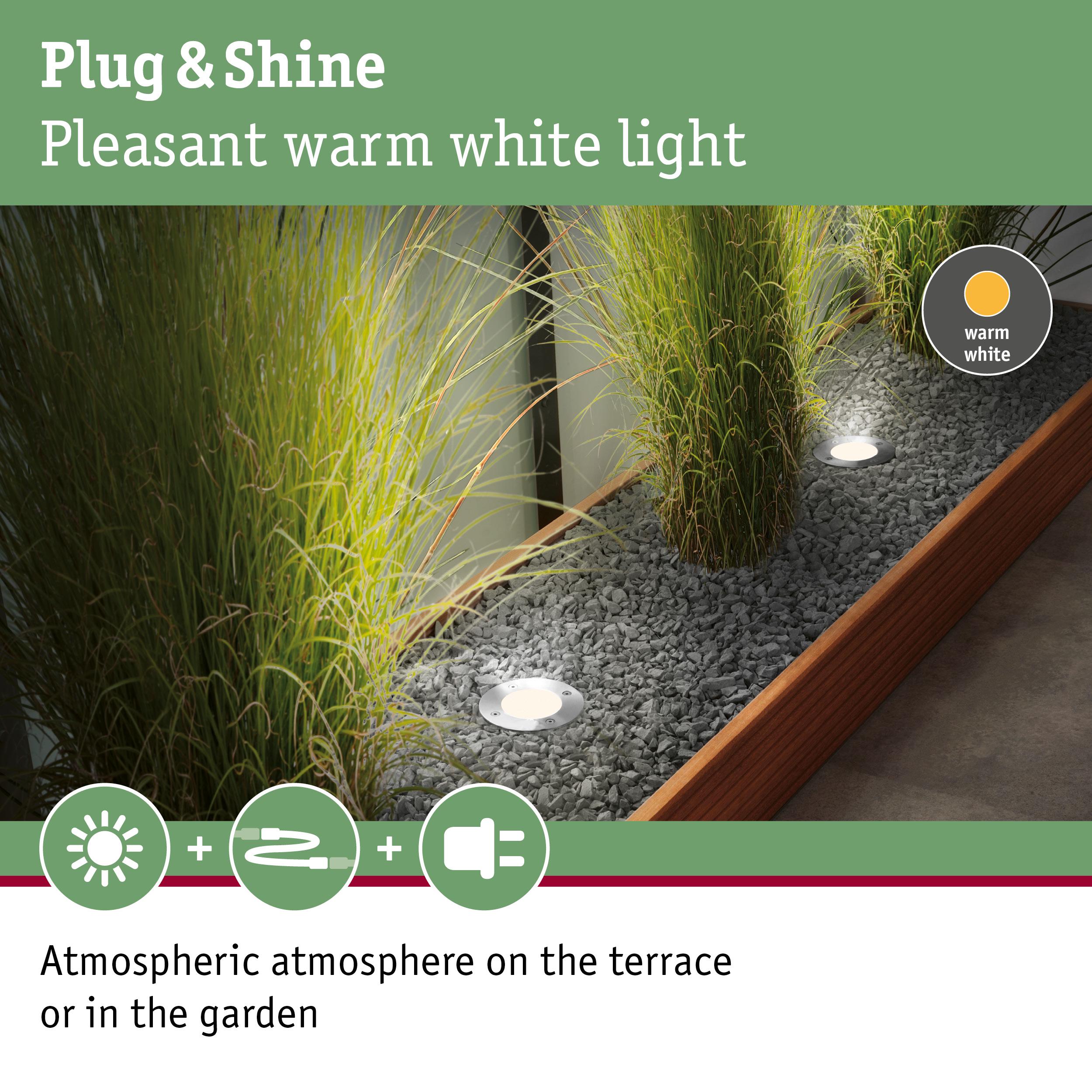 Recessed LED garden lights with warm white light in gravel bed creating atmospheric terrace lighting