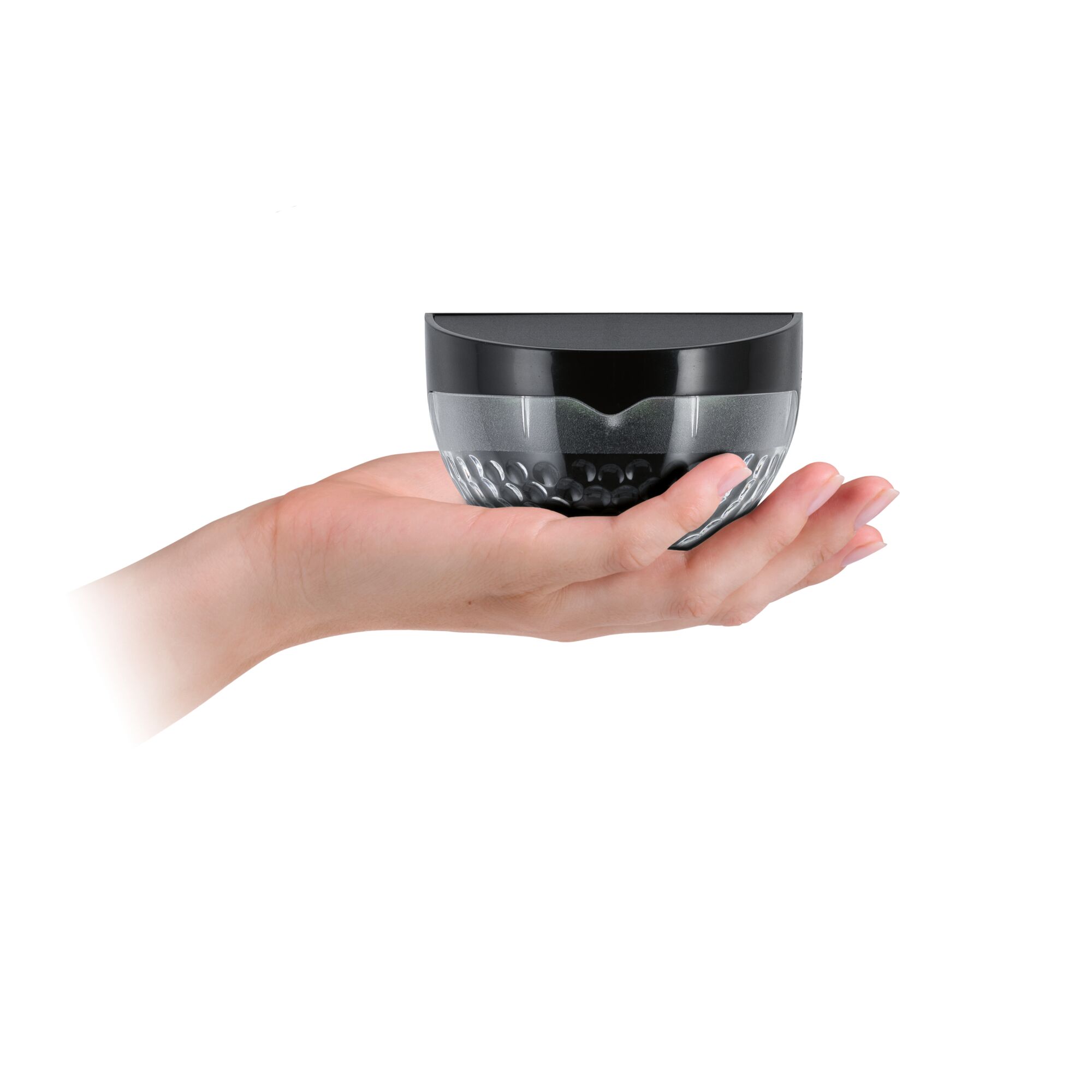 Small black LED light with transparent plastic housing held in hand, compact lighting solution