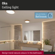 Oka wooden ceiling light in natural tones illuminating modern bathroom with double washbasin