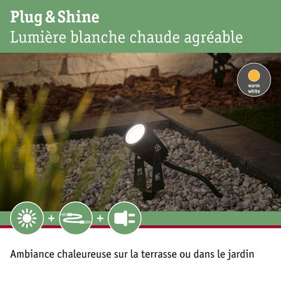 Projecteur LED noir avec lumière blanche chaude sur gravier pour terrasse et jardin