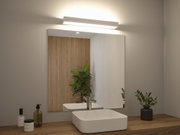 White LED wall light above bathroom mirror with wooden countertop and green plants