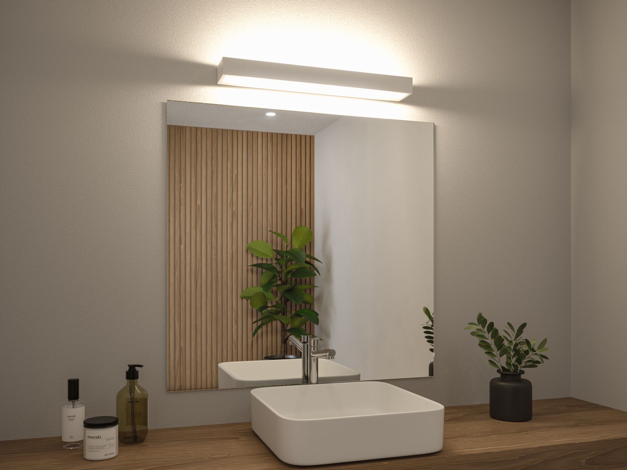 White LED wall light above bathroom mirror with wooden countertop and green plants