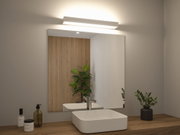 White LED wall light above bathroom mirror with wooden countertop and green plants