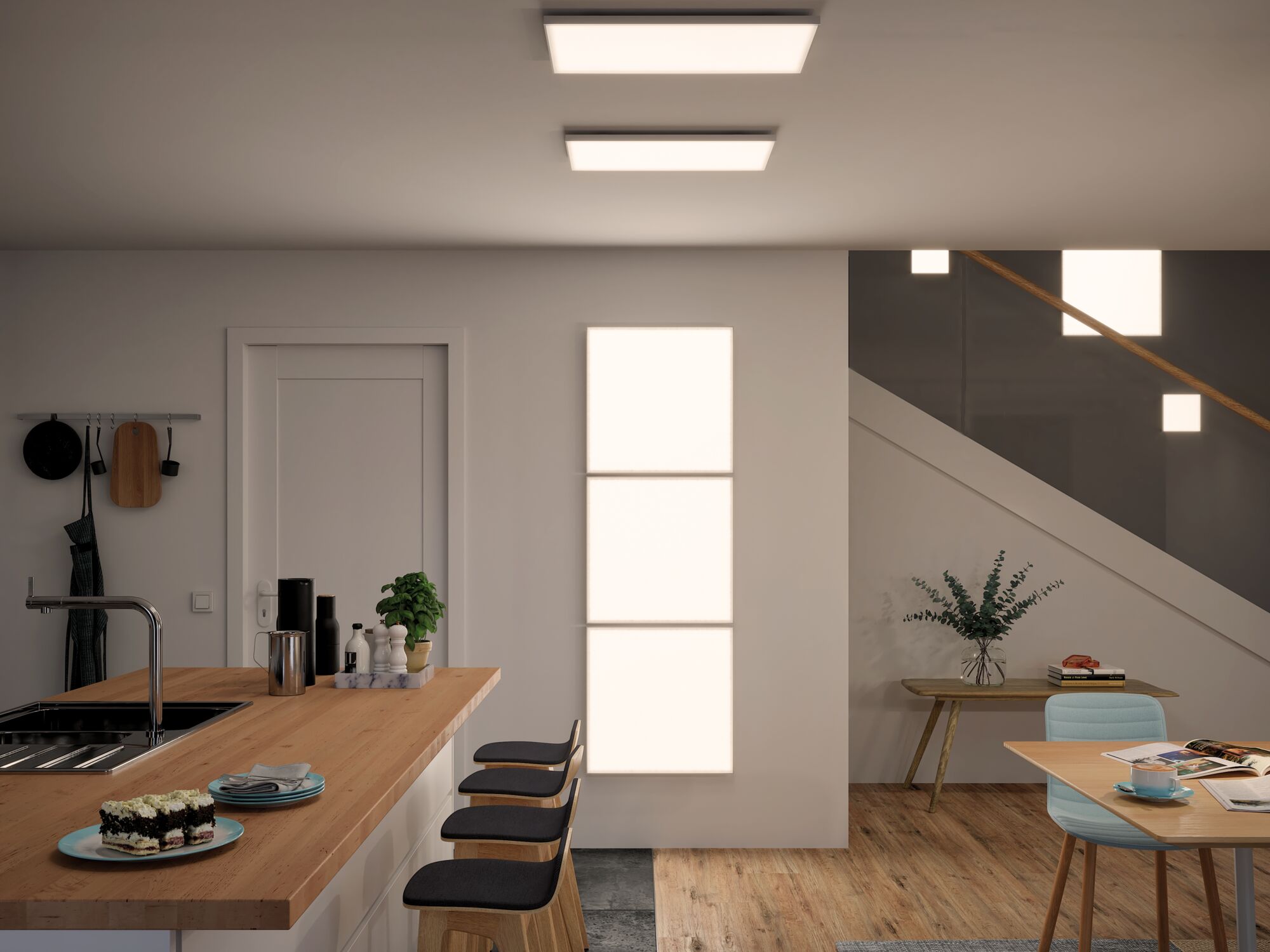 Modern kitchen with wooden countertop and three black bar stools, lit by rectangular LED ceiling lights