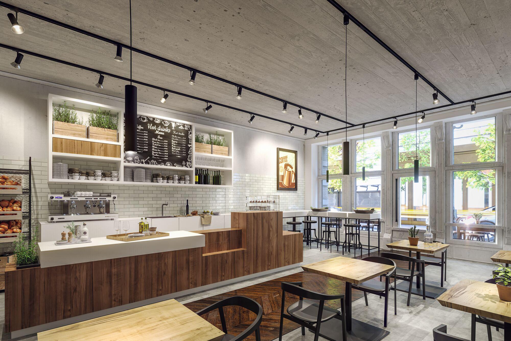 Modern café interior with wooden counter, white tiles, and black LED track lights on concrete ceiling