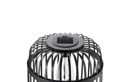 Black solar lamp with metal cage and visible LED bulb for outdoor lighting solutions.
