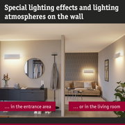 Modern white wall lights in entrance and living room creating atmospheric lighting effects.