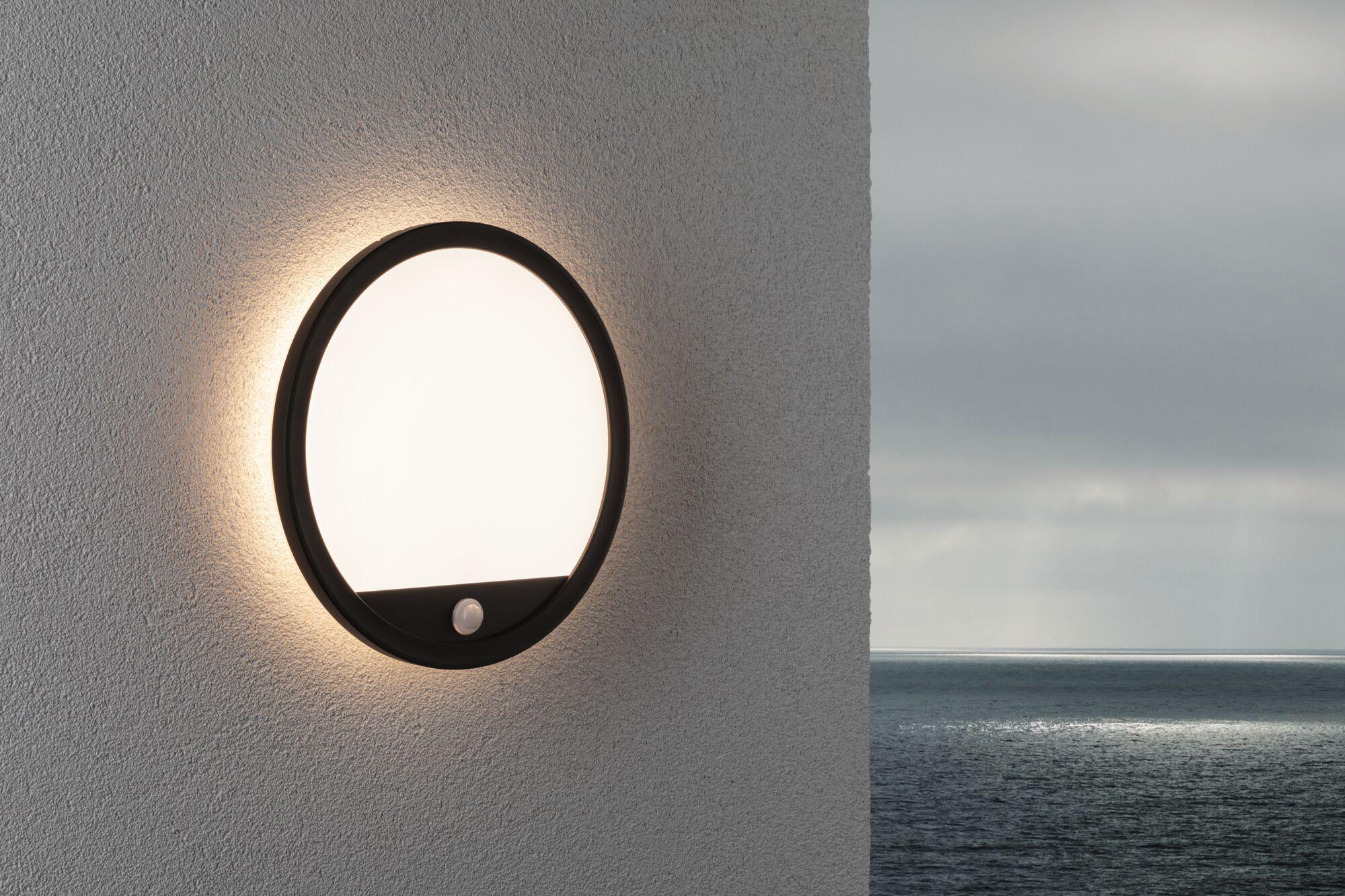 Round black outdoor wall light with white diffuser and motion sensor, weatherproof for garden and terrace