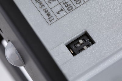 Close-up of white device with black switch and ON/OFF slider for control function.