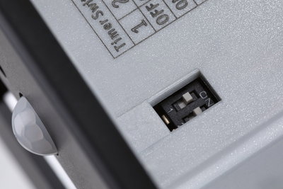 Close-up of white device with black switch and ON/OFF slider for control function.