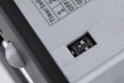 Close-up of white device with black switch and ON/OFF slider for control function.