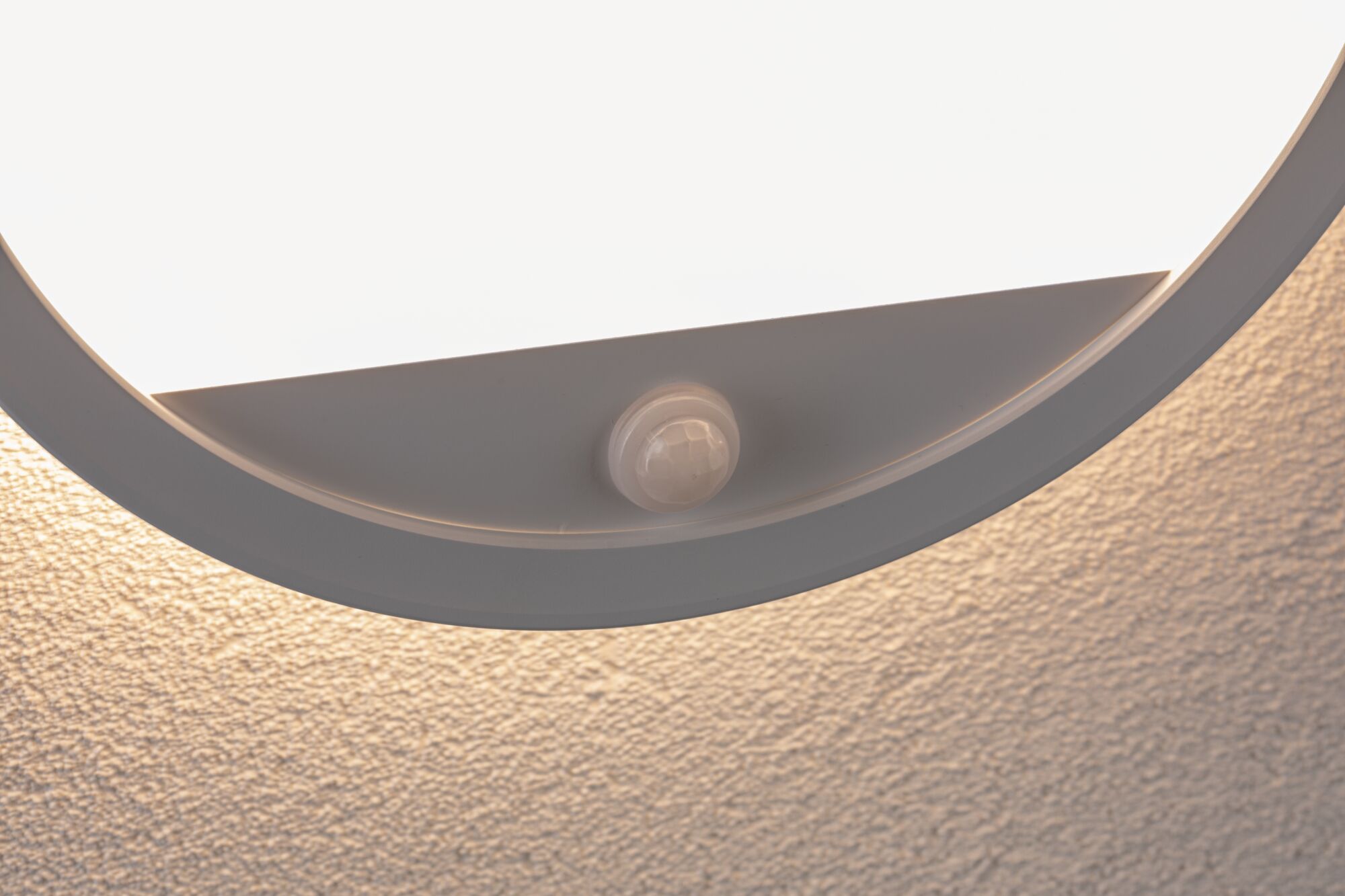Round white ceiling light with built-in motion sensor for energy-efficient lighting