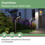 Modern black LED outdoor lights with warm white light creating atmospheric terrace and garden illumination